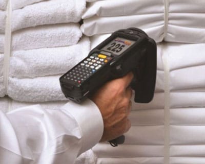 man scanning clean laundry/clothes with rfid handheld reader