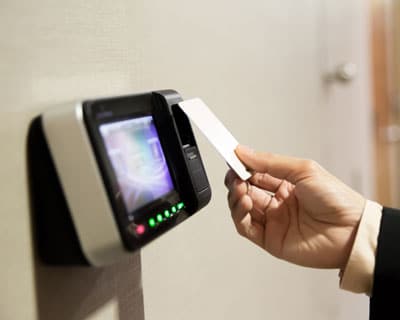 man entering room with contactless rfid smart card and reader terminal