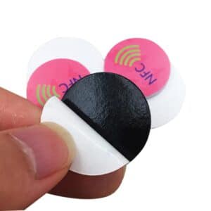 hand holding rfid sticker to show adhesive layer 3M